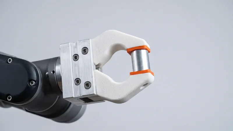 White SLS nylon gripper fingers on an aluminium robot gripper with orange fingertip pads