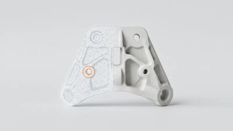 White SLS nylon part half overlaid with a triangle mesh, one mesh hole marked in orange